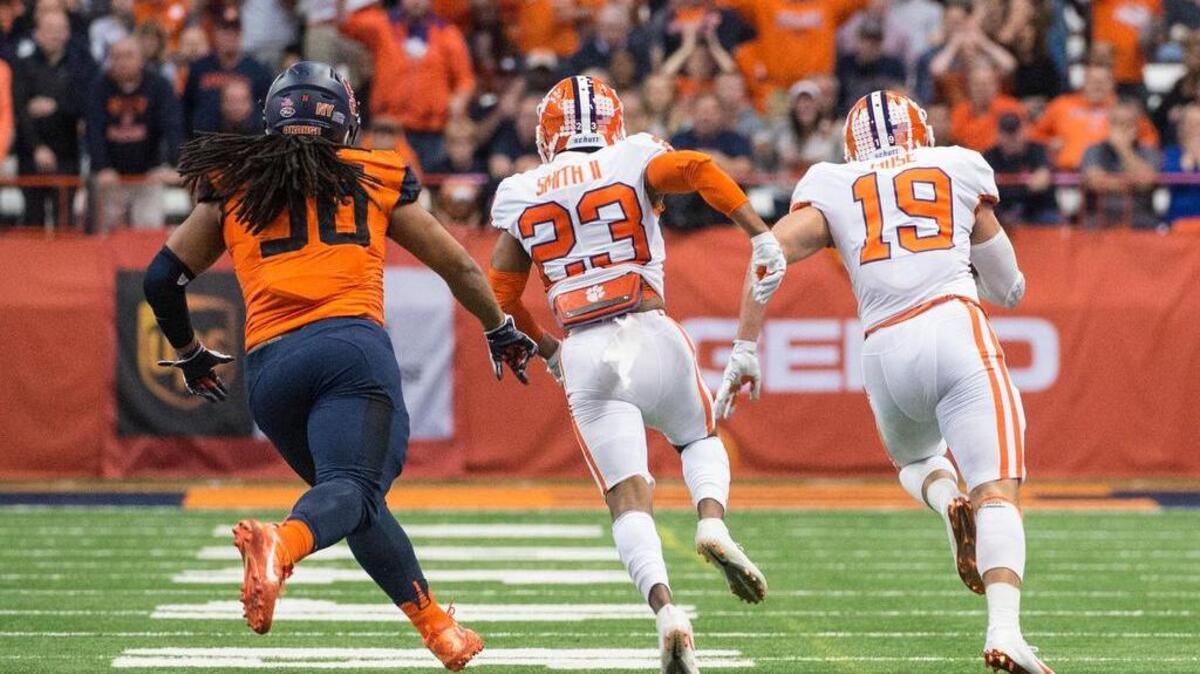 Clemson safety Tanner Muse (19) returns a fumble for a touchdown against Syracuse.