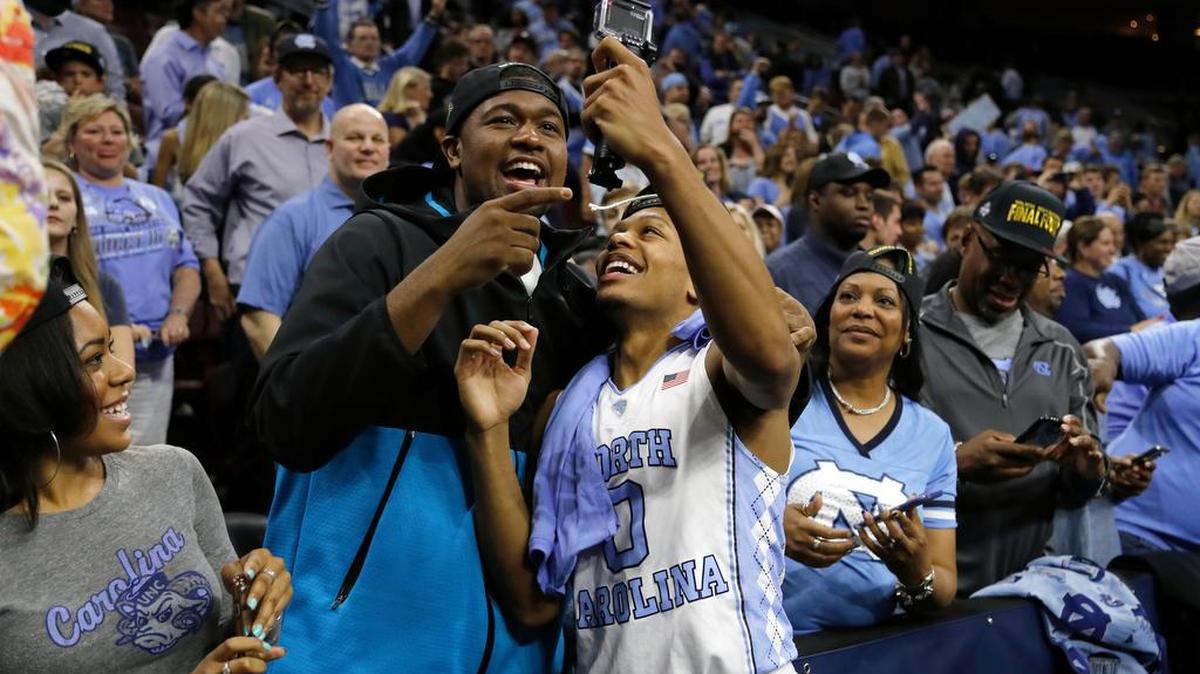 Kris Jenkins, left, celebrates with North Carolina’s Nate Britt, his brother, after the Tar Heels beat Notre Dame to advance to the Final Four, joining Jenkins’ Villanova squad.