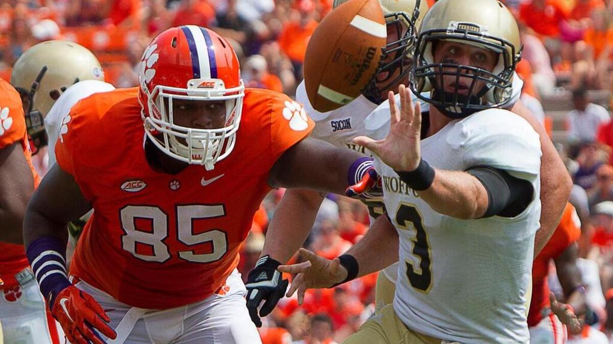 Wofford Terriers quarterback Evan Jacks (3) passes the ball as Clemson Tigers defensive end Dane Rogers (85) defends during the second half at Clemson Memorial Stadium.