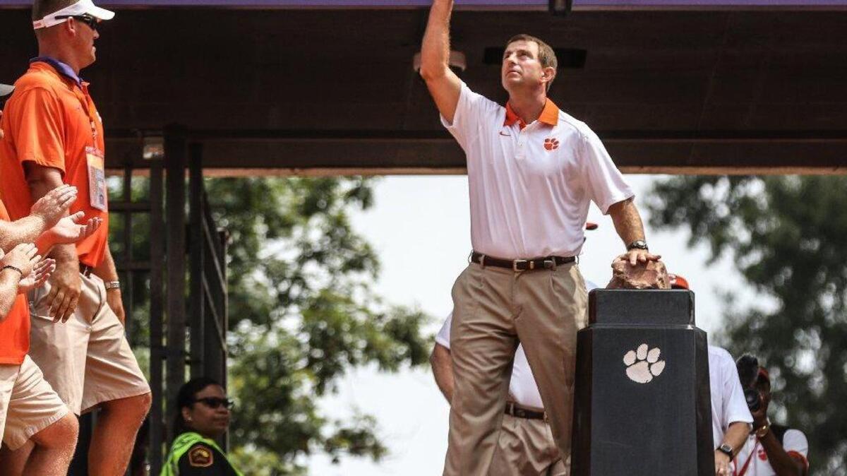 Clemson's Dabo Sweeney touches Howard's Rock upon entering Death Valley. The Clemson Tigers took on the Wofford Terriers for the season opener at Death Valley in Clemson on September 5, 2015.