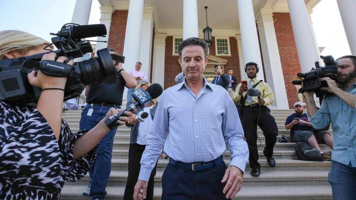 Louisville men's basketball coach Rick Pitino leaves Grawemeyer Hall after having a meeting with the university's interim president Greg Postel on Wednesday in Louisville. Ky. Louisville announced Wednesday that they have placed Pitino and athletic director Tom Jurich on administrative leave amid a federal bribery investigation.