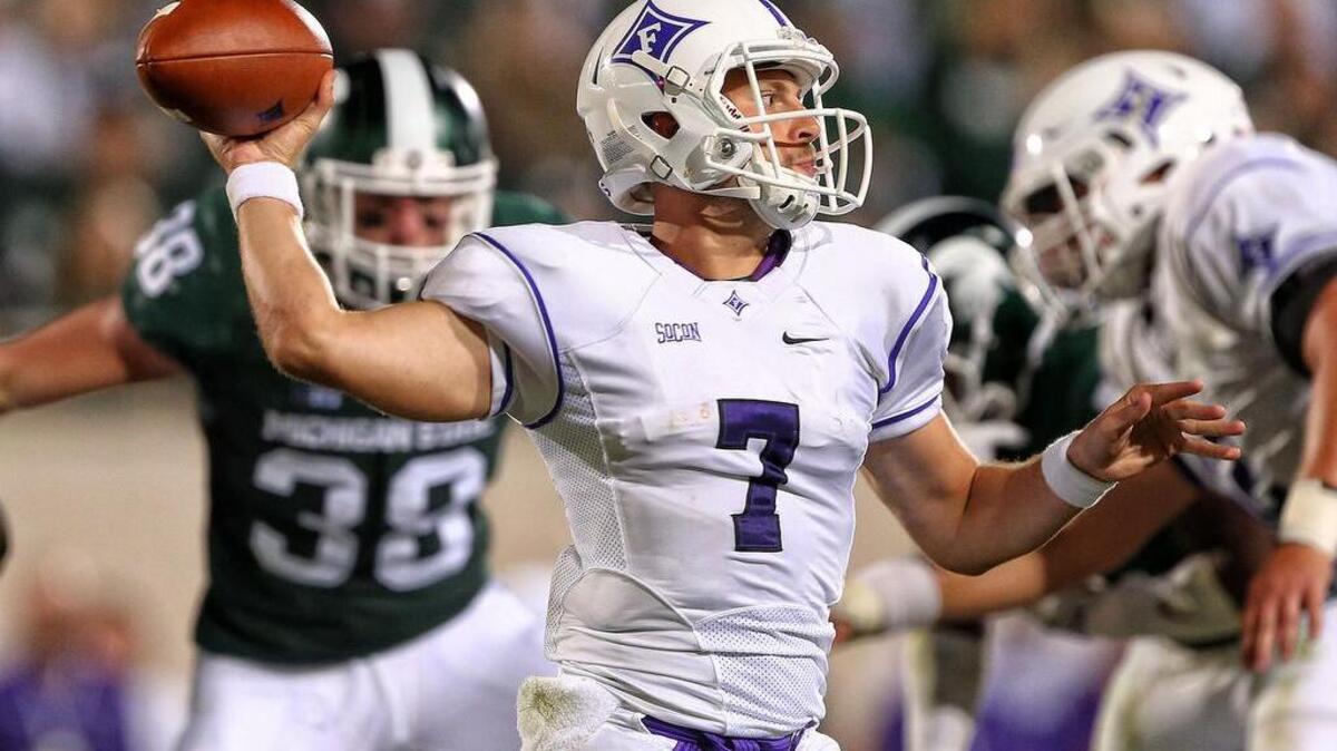 Furman Paladins quarterback P.J. Blazejowski (7) drops back to throw the ball during the second half against the Michigan State Spartans at Spartan Stadium.