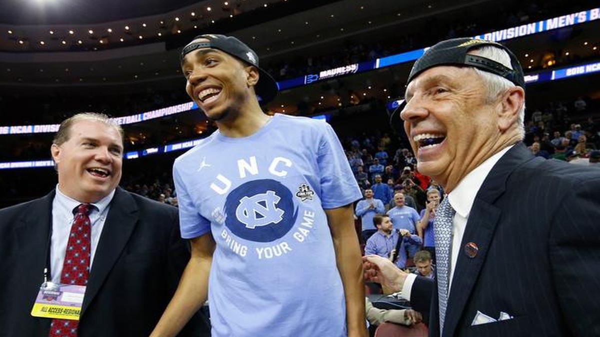 North Carolina's Brice Johnson, center, celebrates with head coach Roy Williams, right, after winning a regional final men's college basketball game against Notre Dame in the NCAA Tournament to advance to the Final Four.