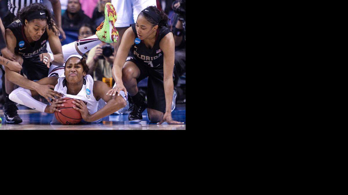 
South Carolina’s Alaina Coates comes up with the ball after battling Florida State’s Ivey Slaughter, left, and Emiah Bingley during the Greesnboro Regional final last week.
