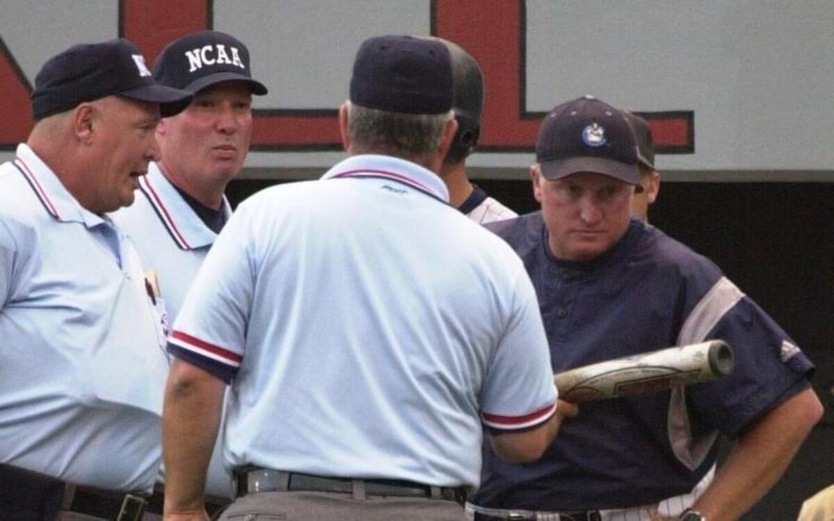 Citadel head coach Fred Jordan (right) examines a bat Dallas McPherson after USC head coach Ray Tanner raised an issue during Regional play in 2001.