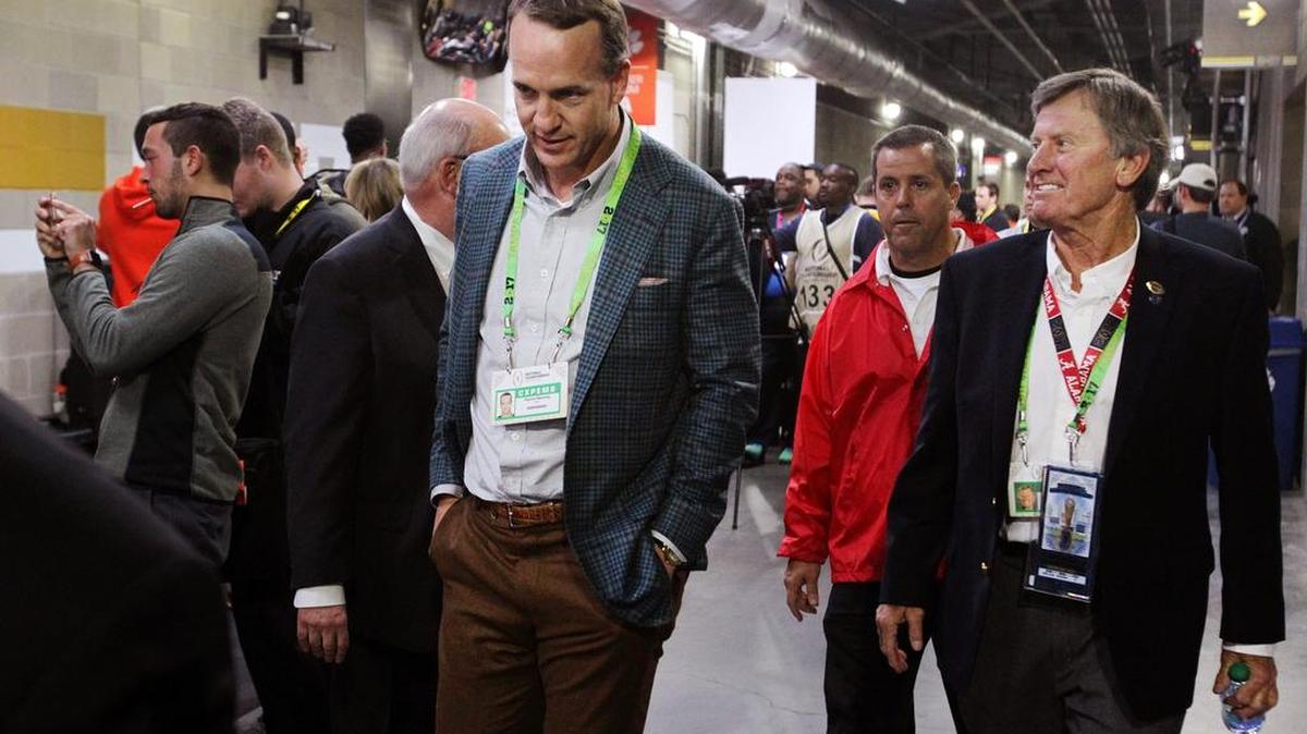 Former South Carolina coach Steve Spurrier walks with NFL great Peyton Manning prior to the start of the National Championship game this past January.