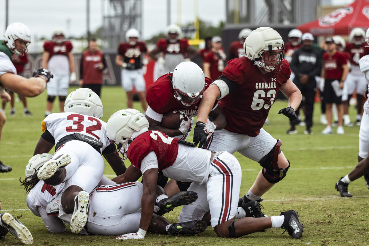 South Carolina offensive lineman Parker Lawson (63) among a scrum of Gamecocks during a South Carolina football practice.