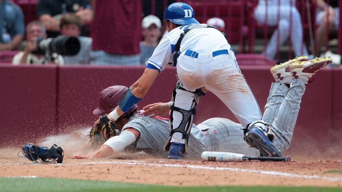 South Carolina’s Clark Scolamiero is tagged out at home by Duke’s Chris Proctor on a bunt that didn’t go as planned during the Gamecocks’ win Saturday.