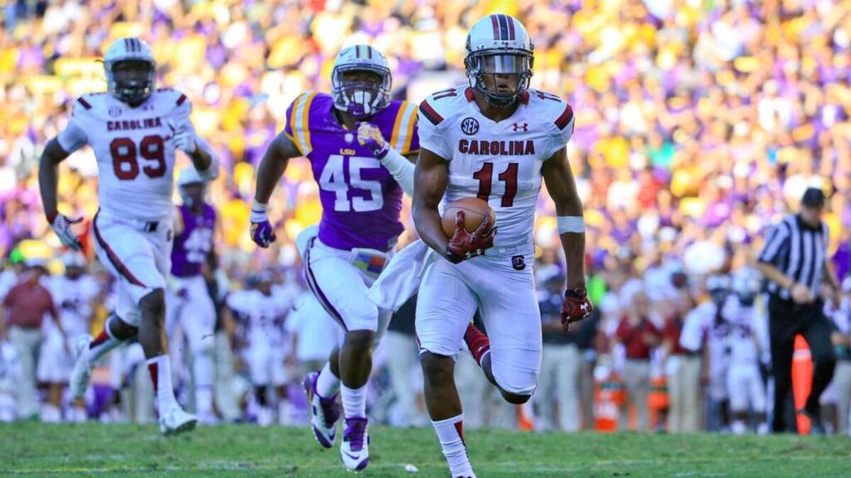 
South Carolina wide receiver Pharoh Cooper (11) runs after a catch for a touchdown against the LSU Tigers during the third quarter of a game at Tiger Stadium. LSU defeated South Carolina 45-24. Mandatory Credit: Derick E. Hingle-USA TODAY Sports
