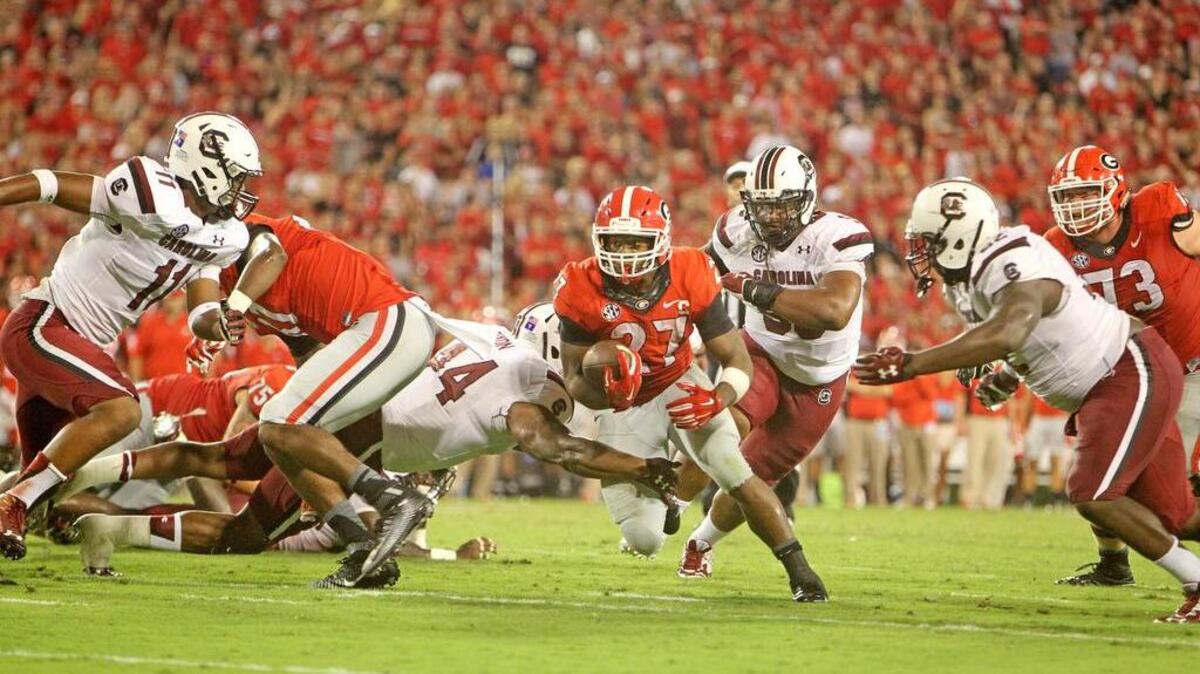 
Georgia running back Nick Chubb breaks through the line on a run Saturday. Chubb and the Georgia offense had their way with the South Carolina defense.
