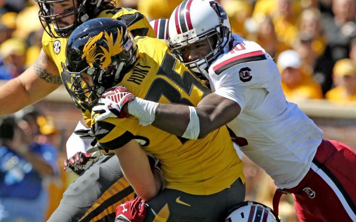 
Missouri's Tyler Hunt is brought down by South Carolina linebacker Skai Moore (10) and defensive end Marquavius Lewis (8).
