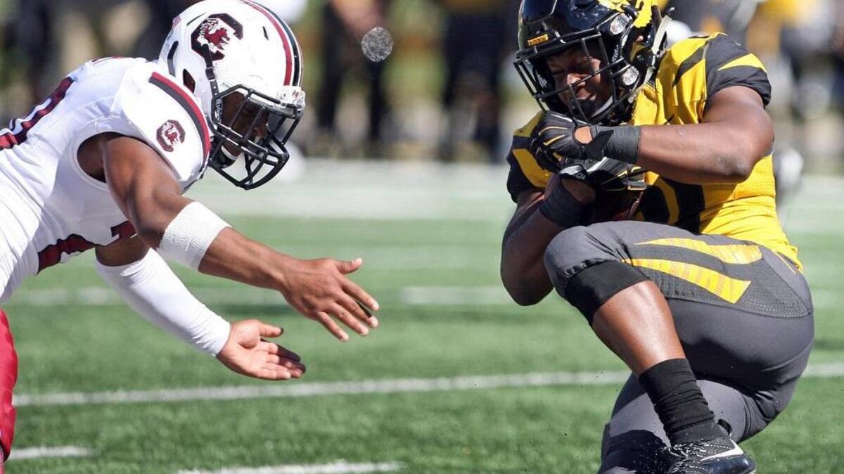 
Missouri running back Ish Witter braces for a hit from South Carolina's T.J. Gurley on Saturday at Faurot Field in Columbia, Mo.
