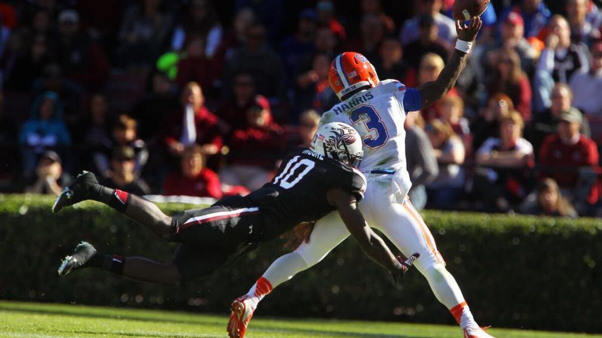 South Carolina linebacker Skai Moore dives to hit Florida quarterback Treon Harris, causing an incomplete pass in the second half at Williams-Brice Stadium.