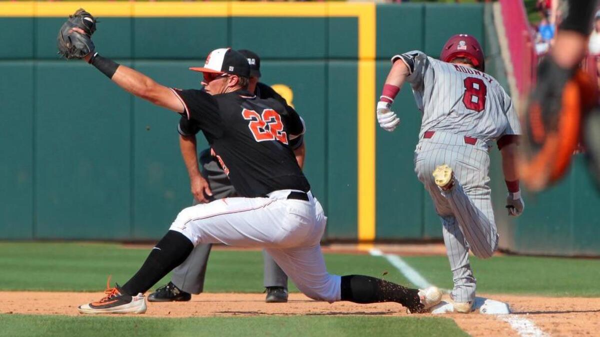 South Carolina’s Marcus Mooney can't beat out the throw to first as Oklahoma State’s Dustin Williams completes the double play. USC’s offense struggled against the Cowboys in the Super Regional, scoring two runs in 18 innings.