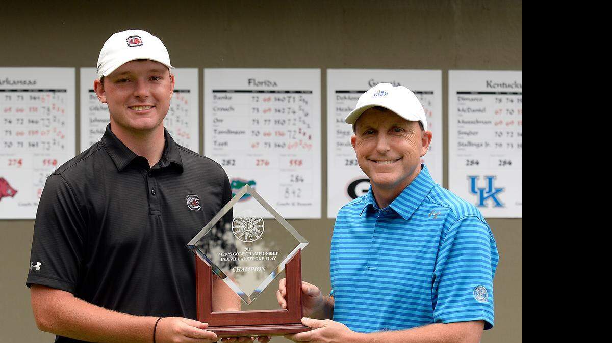 
South Carolina junior Matt NeSmith is presented the SEC championship trophy
