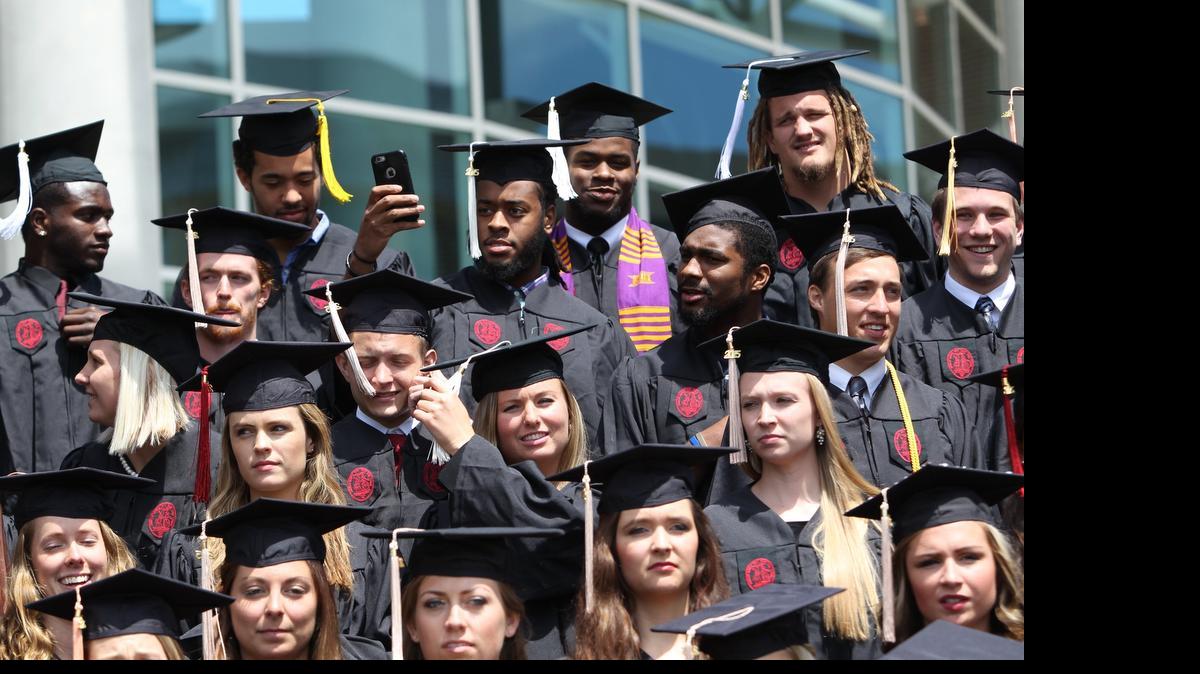
About 75 student athletes pose for group photographs in advance of their graduations. Commencement exercises begin next week. 
