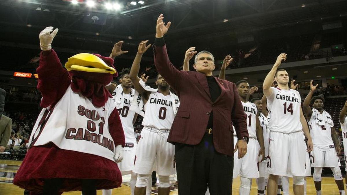 USC Coach Frank Martin and members of the men's basketball team sing the alma mater after a game this past season. The Gamecocks men’s and women’s basketball teams beat Clemson.