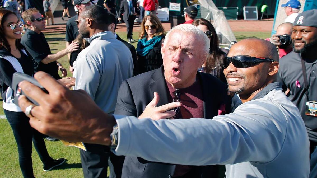 Retired professional wrestler Ric Flair "The Nature Boy" (left) poses with former Jacksonville Jaguars safety Donovin Darius.