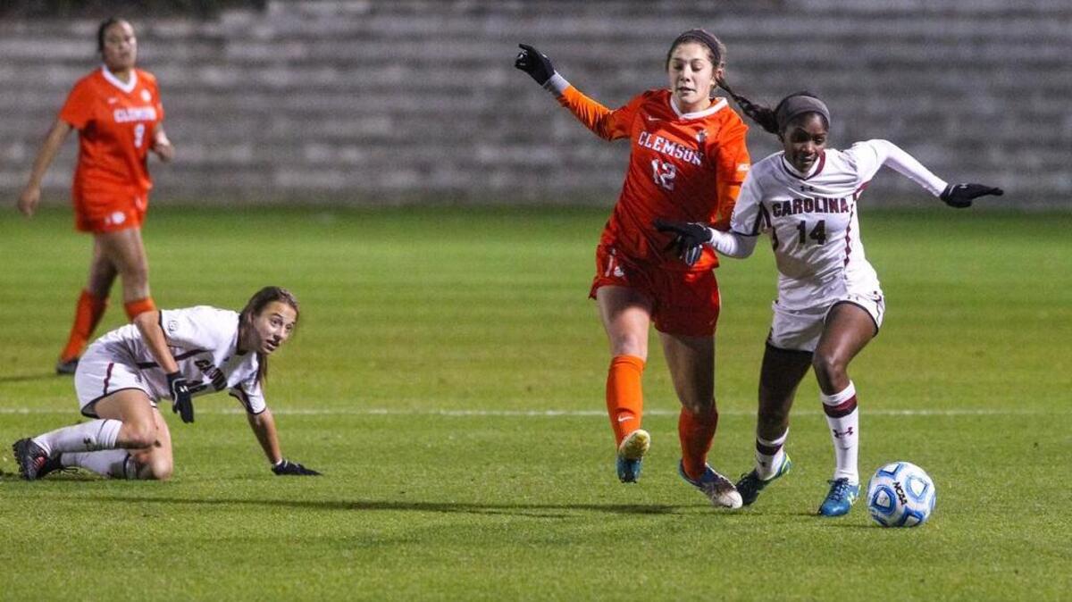 
South Carolina’s Daija Griffin (14) dribbles past Clemson’s Katelyn Reeve (12) during the Gamecocks’ 4-3 win last year. The Palmetto State squads will renew their rivalry Friday.
