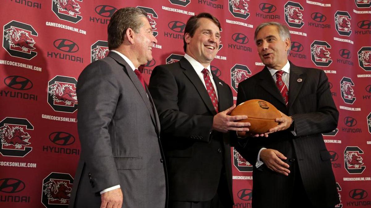 USC president Harris Pastides, right, with athletics director Ray Tanner, left, and football coach Will Muschamp.