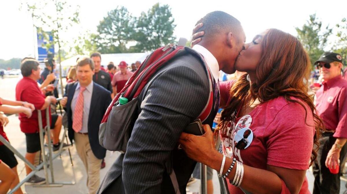South Carolina Gamecocks linebacker Bryson Allen-Williams gets a kiss from his mother Darnisha Allen-Jackson as the team arrives at Commonwealth Stadium in Lexington, Ky.
