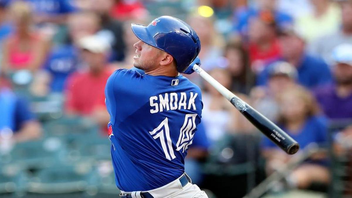 Toronto Blue Jays first baseman Justin Smoak (14) hits a home run during the second inning June 19 against the Texas Rangers at Globe Life Park in Arlington.
