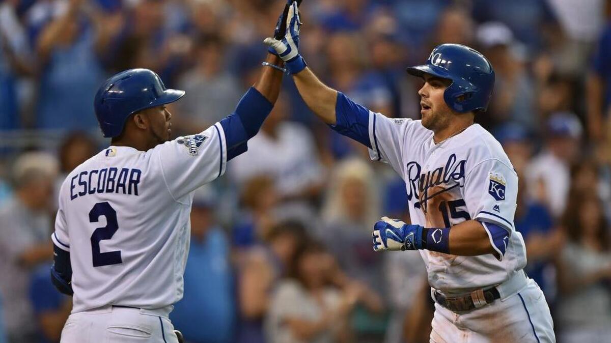 Kansas City Royals second basemen Whit Merrifield (15) celebrates with teammate Alcides Escobar (2) after hitting a solo home run against the Cleveland Indians during the fourth inning at Kauffman Stadium.