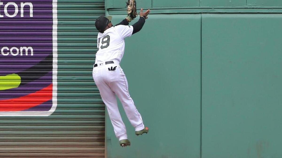 Boston Red Sox center fielder Jackie Bradley Jr. catches a deep fly ball by Toronto Blue Jays designated hitter Kendrys Morales in the sixth inning of a baseball game at Fenway Park, Monday, May 28, 2018, in Boston.