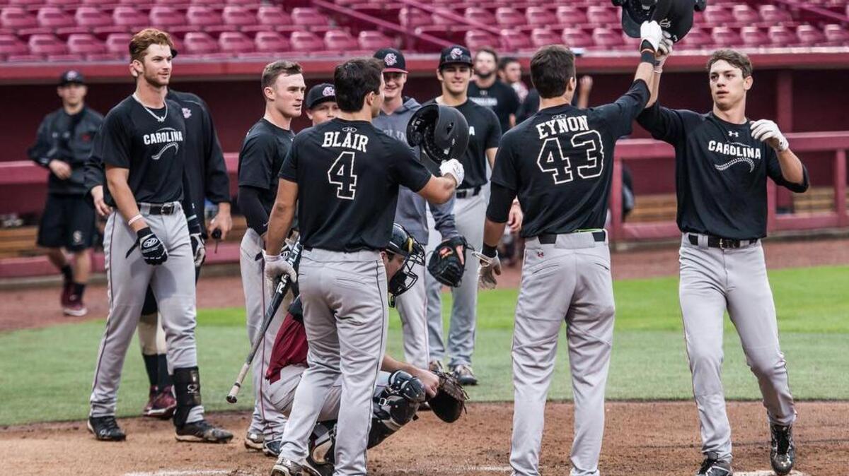 TJ Hopkins celebrates a homer with his teammates on the black team Sunday during the Garnet & Black World Series at Founders Park. The Black team prevailed in the six-inning scrimmage, regularly held at the conclusion of fall practice.