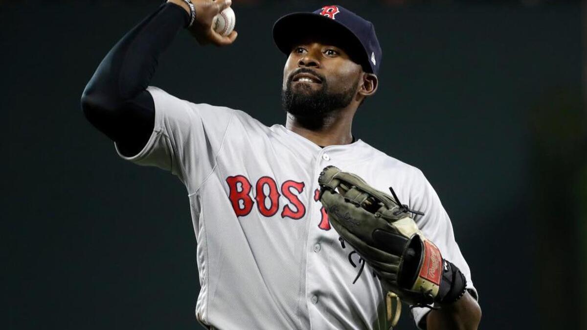 Former South Carolina star Jackie Bradley Jr., now the Boston Red Sox center fielder, throws a ball into the stands as he jogs off the field between innings of a baseball game against the Baltimore Orioles.