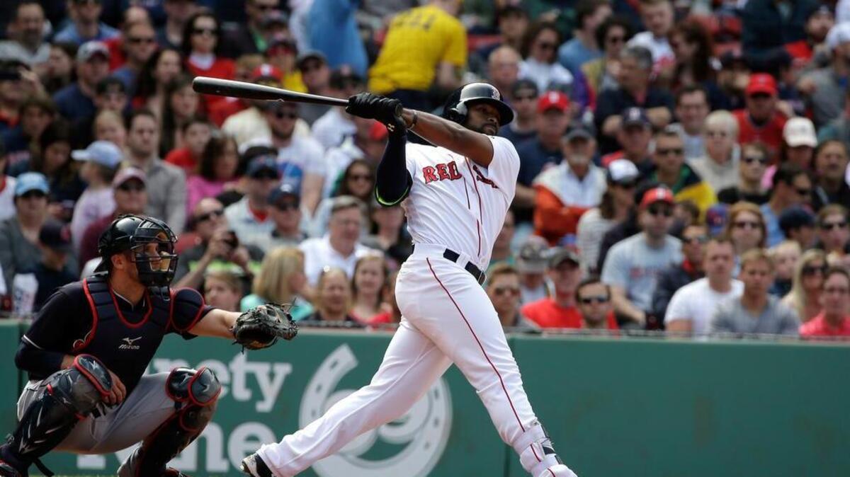 Boston Red Sox's Jackie Bradley Jr., right, singles as Cleveland Indians' Yan Gomes, left, looks on in the fifth inning of a baseball game at Fenway Park, Sunday, May 22, 2016, in Boston.