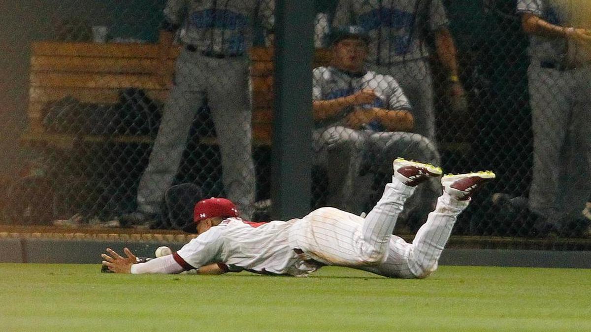 South Carolina's Dom Thompson-Williams dives but can't come up with a long hit by Rhode Island Friday at Founders Park in the NCAA Baseball Tournament's Columbia Regional.