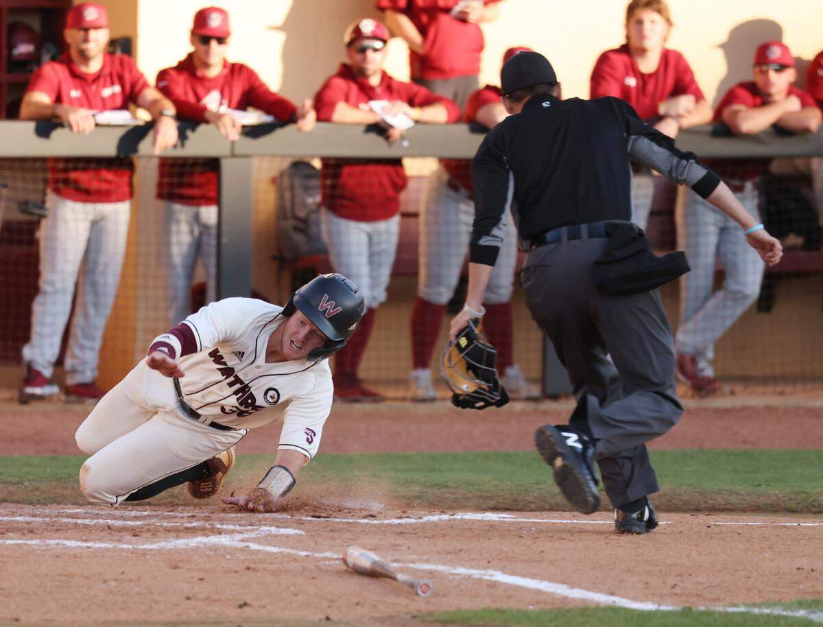 Winthrop University’s Ty Hooks slides into home Wednesday at the Winthrop Ballpark in Rock Hill, S.C.