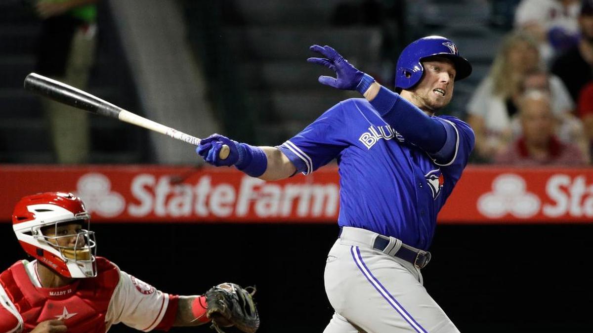 Toronto’s Justin Smoak, a South Carolina alum, follows through on a two-run double.
