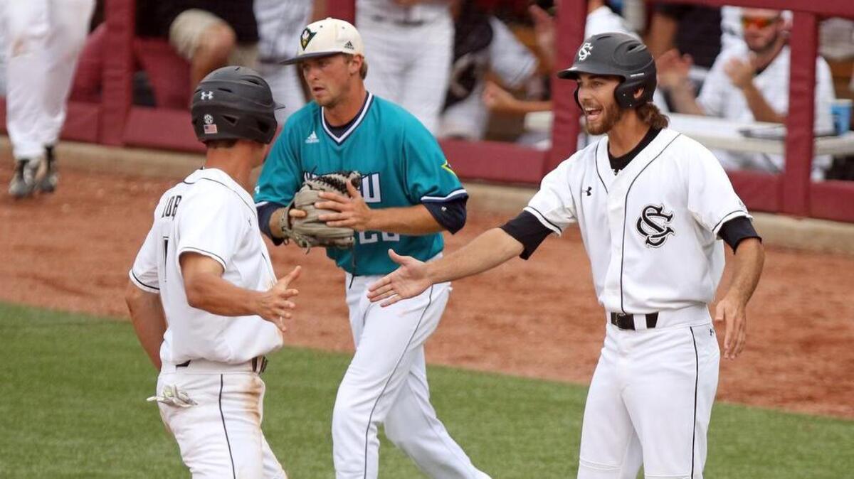 TJ Hopkins and Gene Cone celebrate their runs scored Sunday night vs. UNCW.