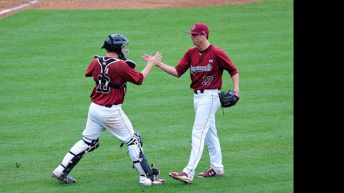 
USC pitcher Taylor Widener (17) and catcher Logan Koch celebrate their come-from-behind win against Vanderbilt. After a slow start the Gamecocks got moving in the 6th inning and took a 3-2 lead.
