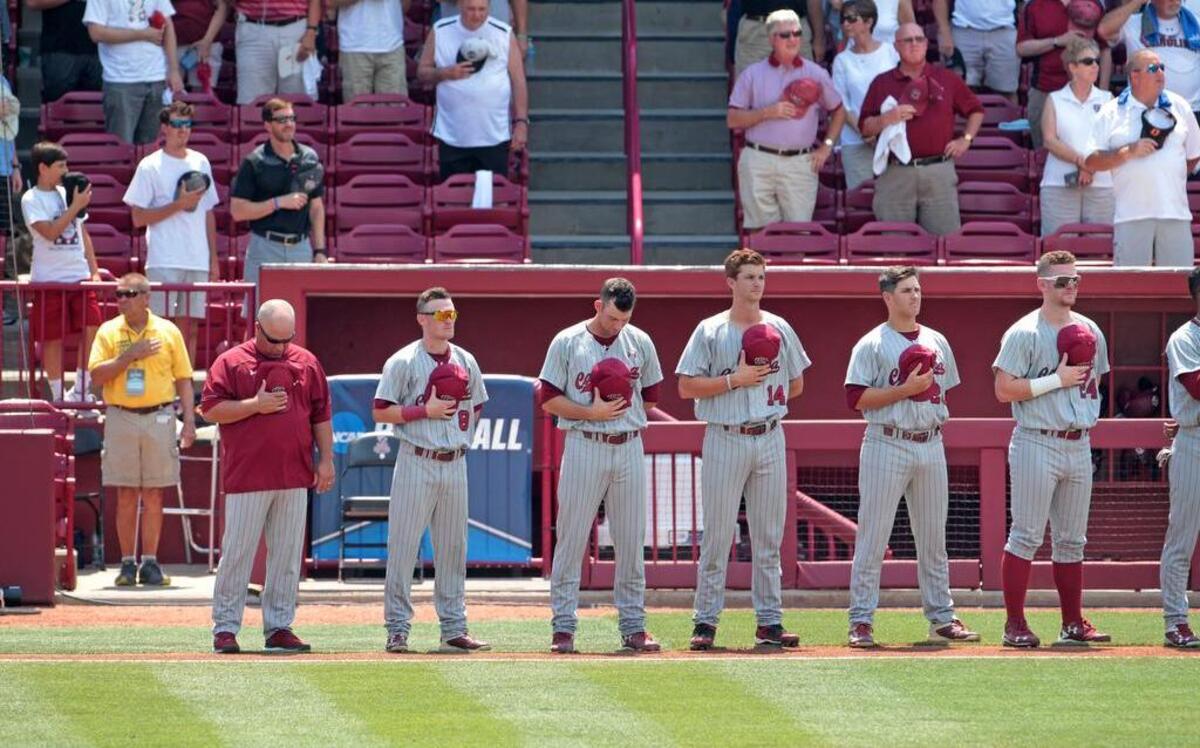 South Carolina head coach Chad Holbrook and his team stand for the National Anthem