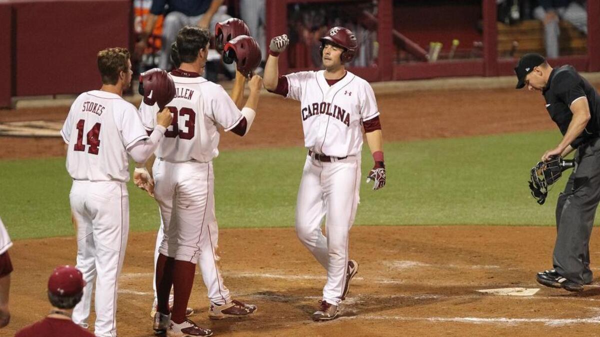 South Carolina's DC Arendas, right, is welcomed home after hitting a grand slam in the fifth inning of the Gamecocks’ victory over The Citadel at Founder's Park on Tuesday.
