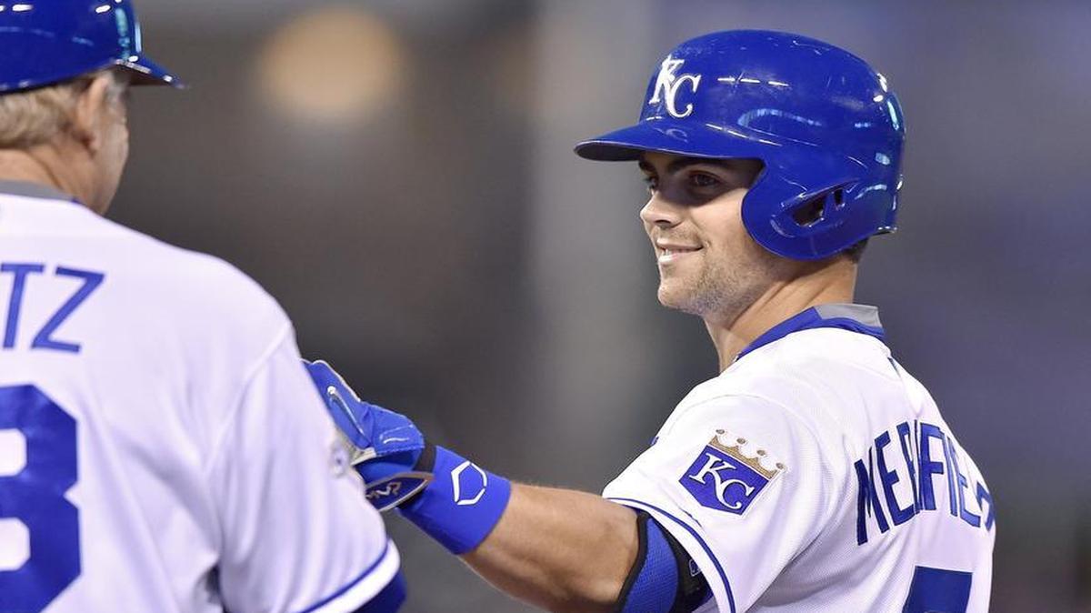 Kansas City Royals' Whit Merrifield is congratulated by first base coach Rusty Kuntz on his first major league hit in the fifth inning for a single during Wednesday's second of a split doubleheader baseball game against the Boston Red Sox at Kauffman Stadium in Kansas City, Mo.