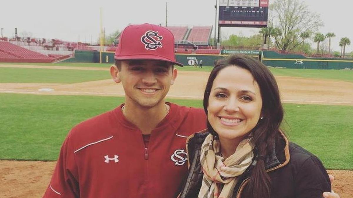 John Hawkins, who is a Stage IV Hodgkin's Lymphoma survivor, is a senior at USC and is a bullpen catcher for USC baseball team. He poses with his sister Lauren Dion at Founders Park.