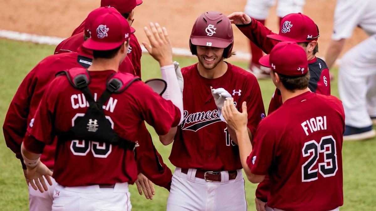South Carolina right fielder Gene Cone is congratulated after scoring against the Arkansas during a game on March 20.