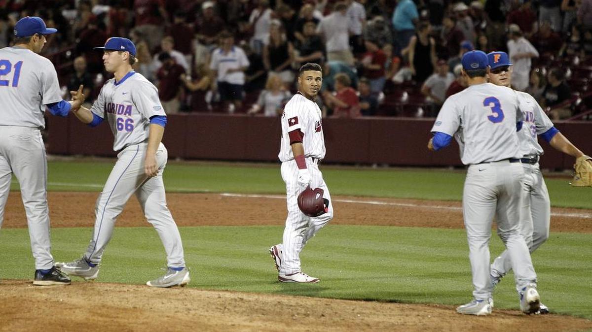 South Carolina's Dom Thompson-Williams watches as Florida players celebrate their win at Founders Park in Columbia on Friday.