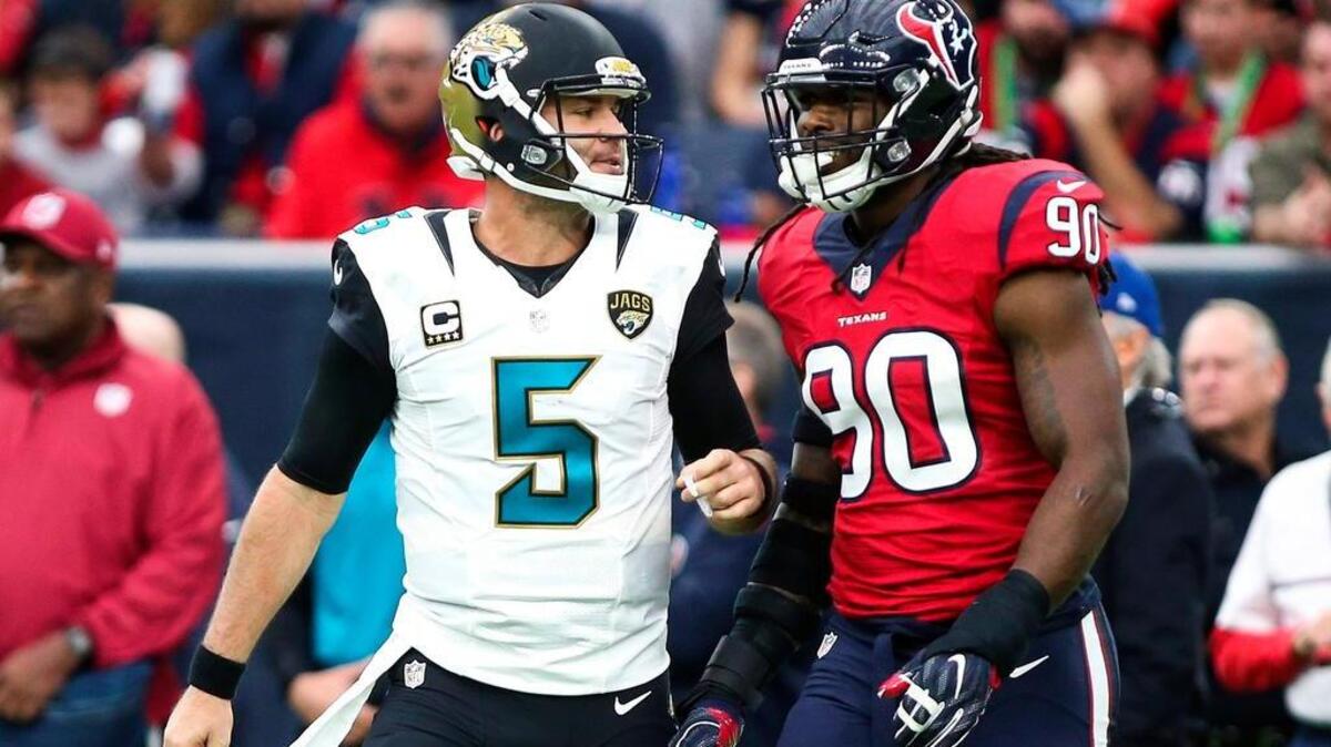 Jacksonville Jaguars quarterback Blake Bortles (5) talks with Houston Texans defensive end Jadeveon Clowney (90) after a play during the first quarter at NRG Stadium.