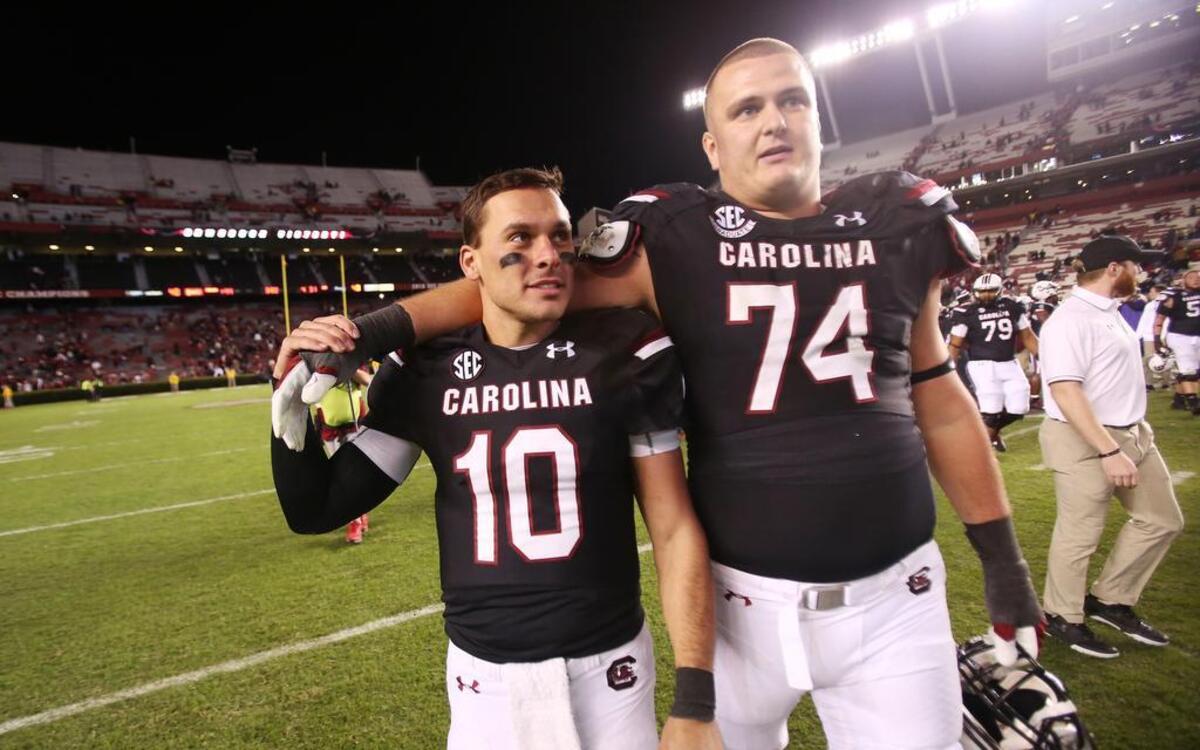 Seniors Perry Orth (10) and Mason Zandi (74) walk off the field for a final time at Williams-Brice Stadiu.