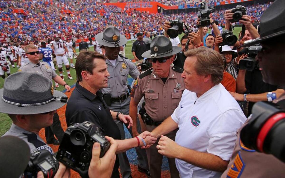 South Carolina Gamecocks head coach Will Muschamp and Florida head coach Jim McElwain shake hands after the game at Ben Hill Griffin Stadium.