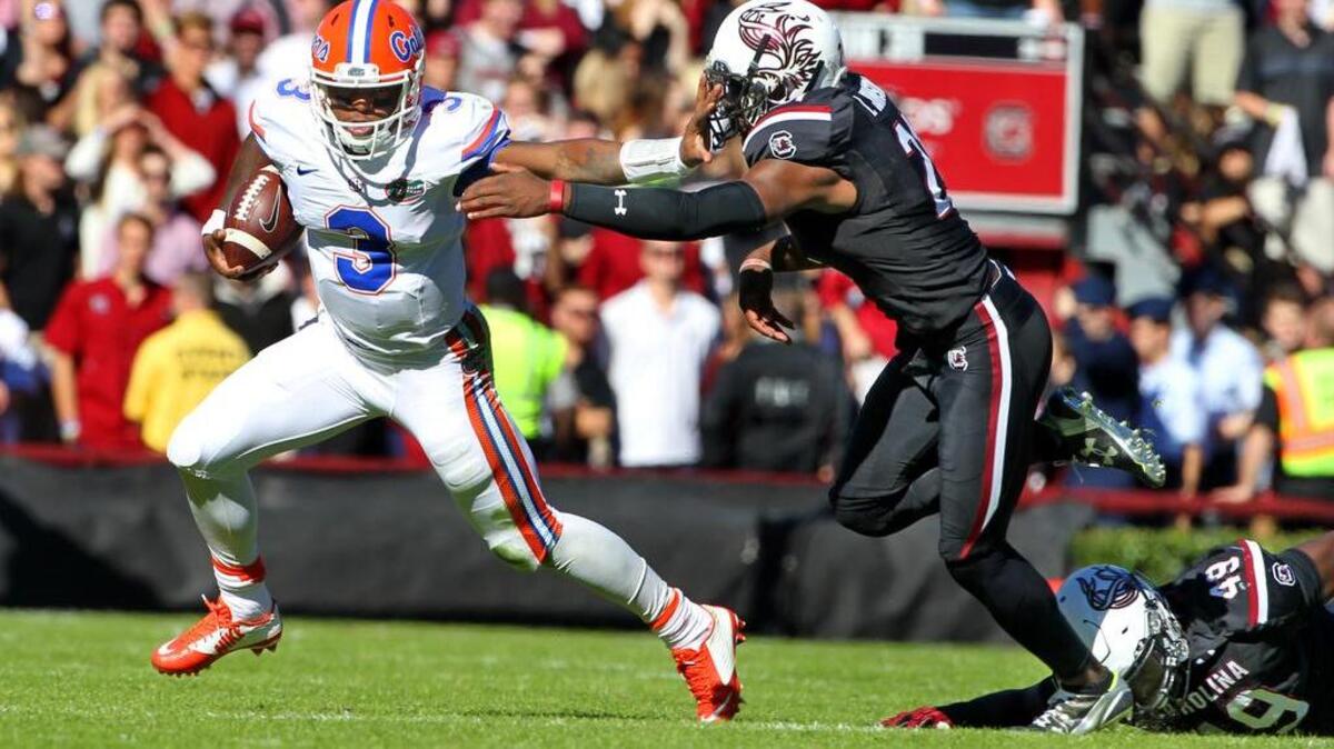 Florida quarterback Treon Harris (3) gets past South Carolina safety Isaiah Johnson (21) Williams-Brice Stadium.