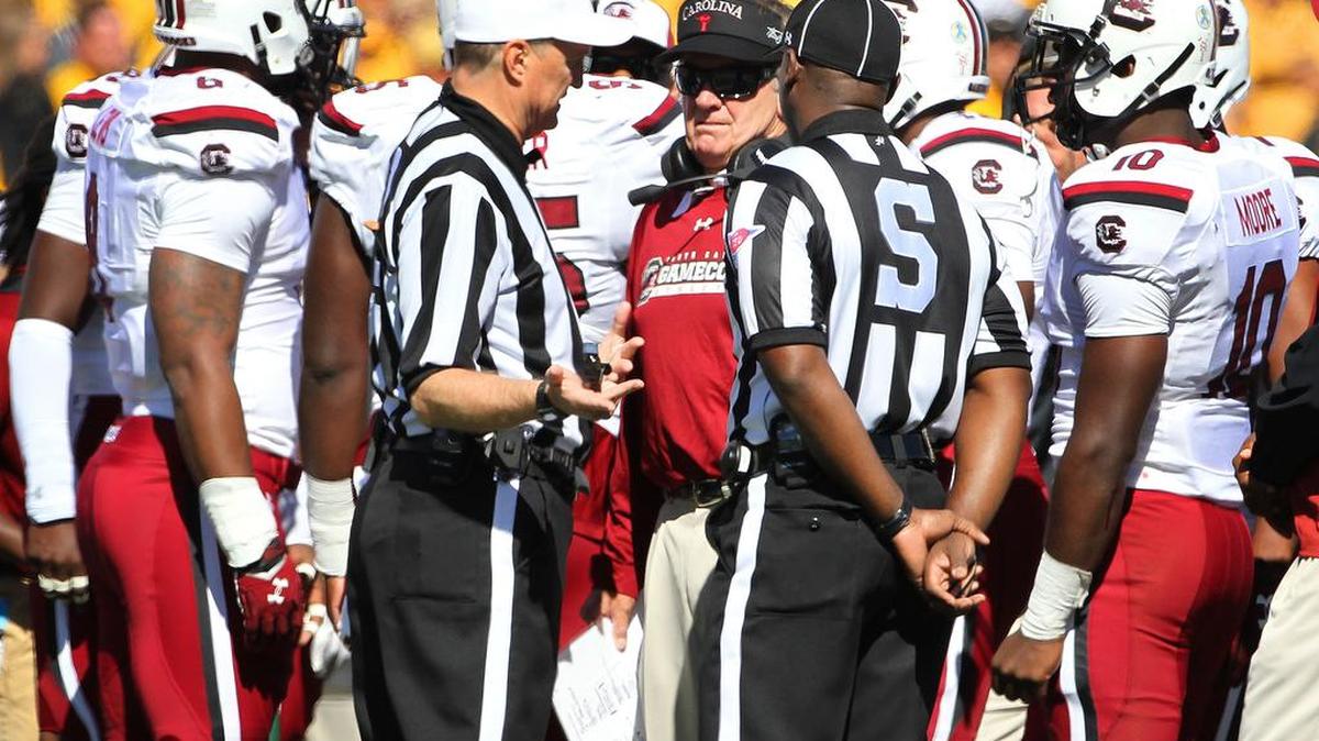 
USC head football coach Steve Spurrier talks to the referees about a Cedrick Cooper tackle that Spurrier though should be a safety.
