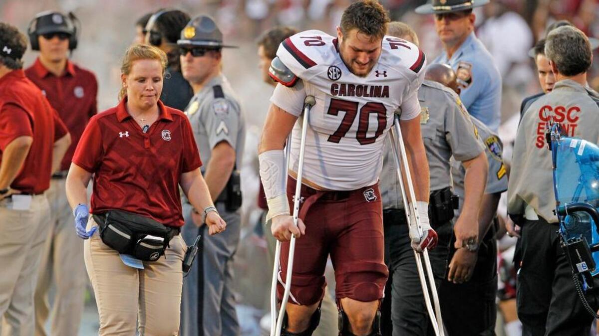 
South Carolina center Alan Knott walks off the field after an injury in the first half against Georgia on Saturday.
