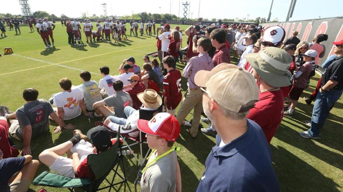 People flocked to the USC practice field for the first football practice of the season that was open to the public.