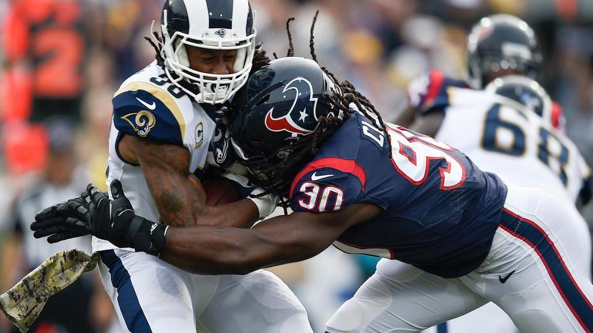 Houston Texans defensive end Jadeveon Clowney (90) tackles Los Angeles Rams running back Todd Gurley II (30) during the first quarter at Los Angeles Memorial Coliseum.